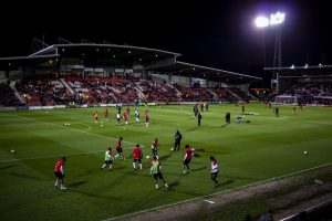 Wales players warm up at the Racecourse Ground