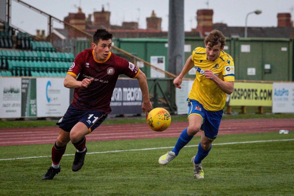 Jordan Lam and Chris Hugh competing for the ball