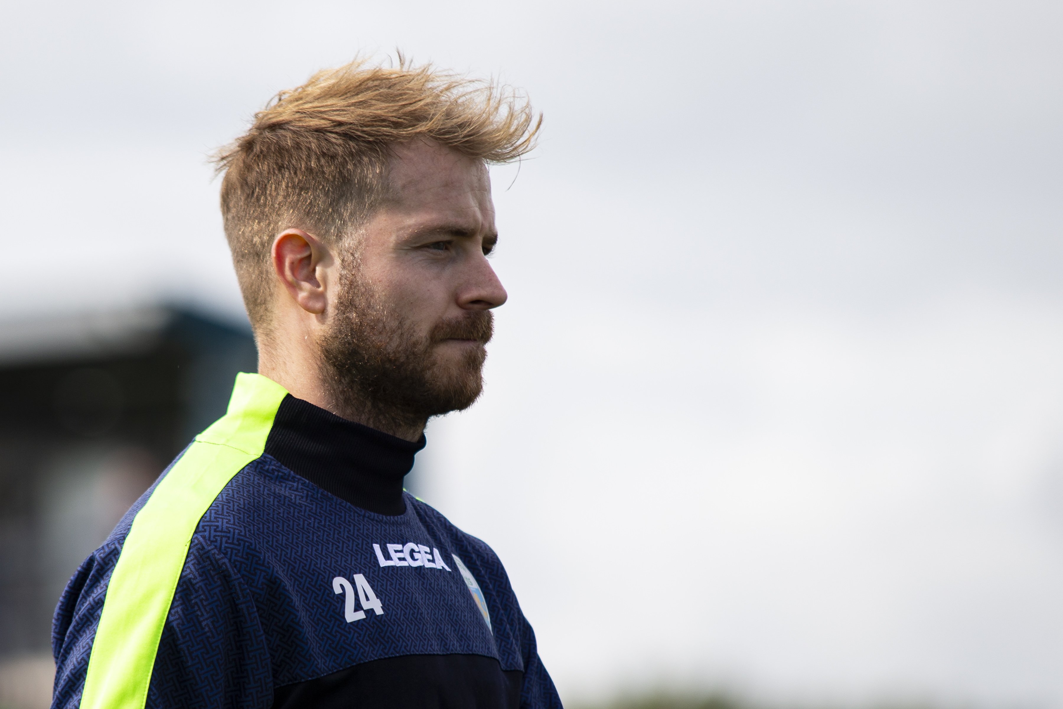 Ash Baker in a New Saints tracksuit poses before kick-off