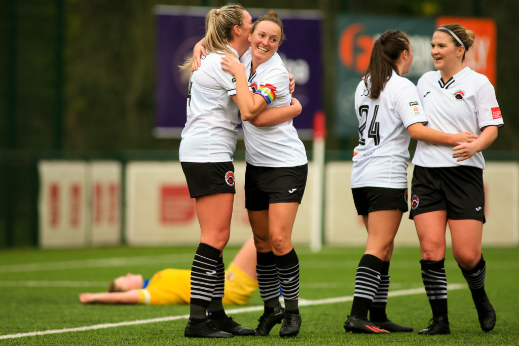 Pontypridd United's Women players celebrate scoring a goal. 