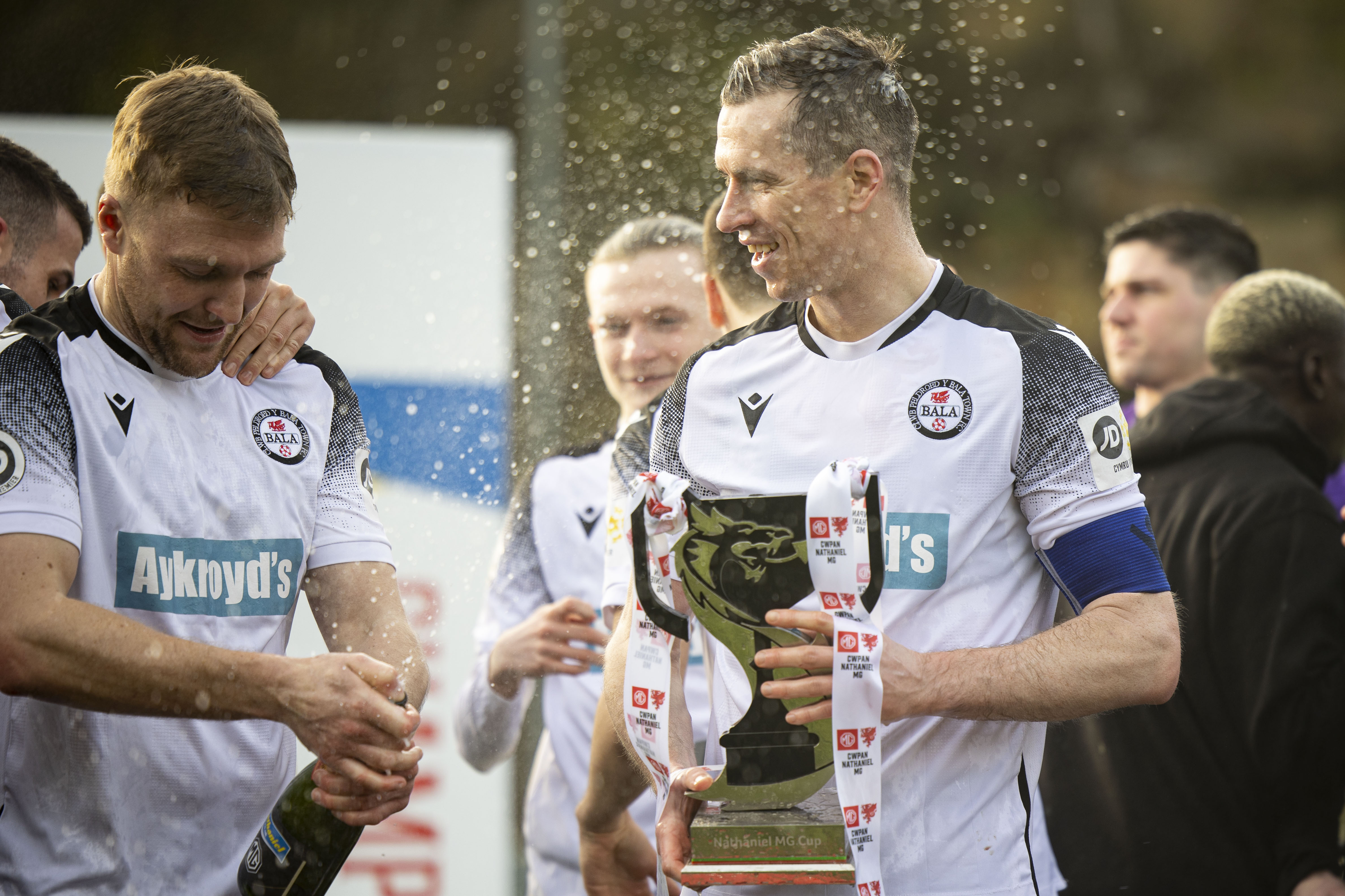 Bala Town player Chris Venables holding the Nathaniel MG Cup