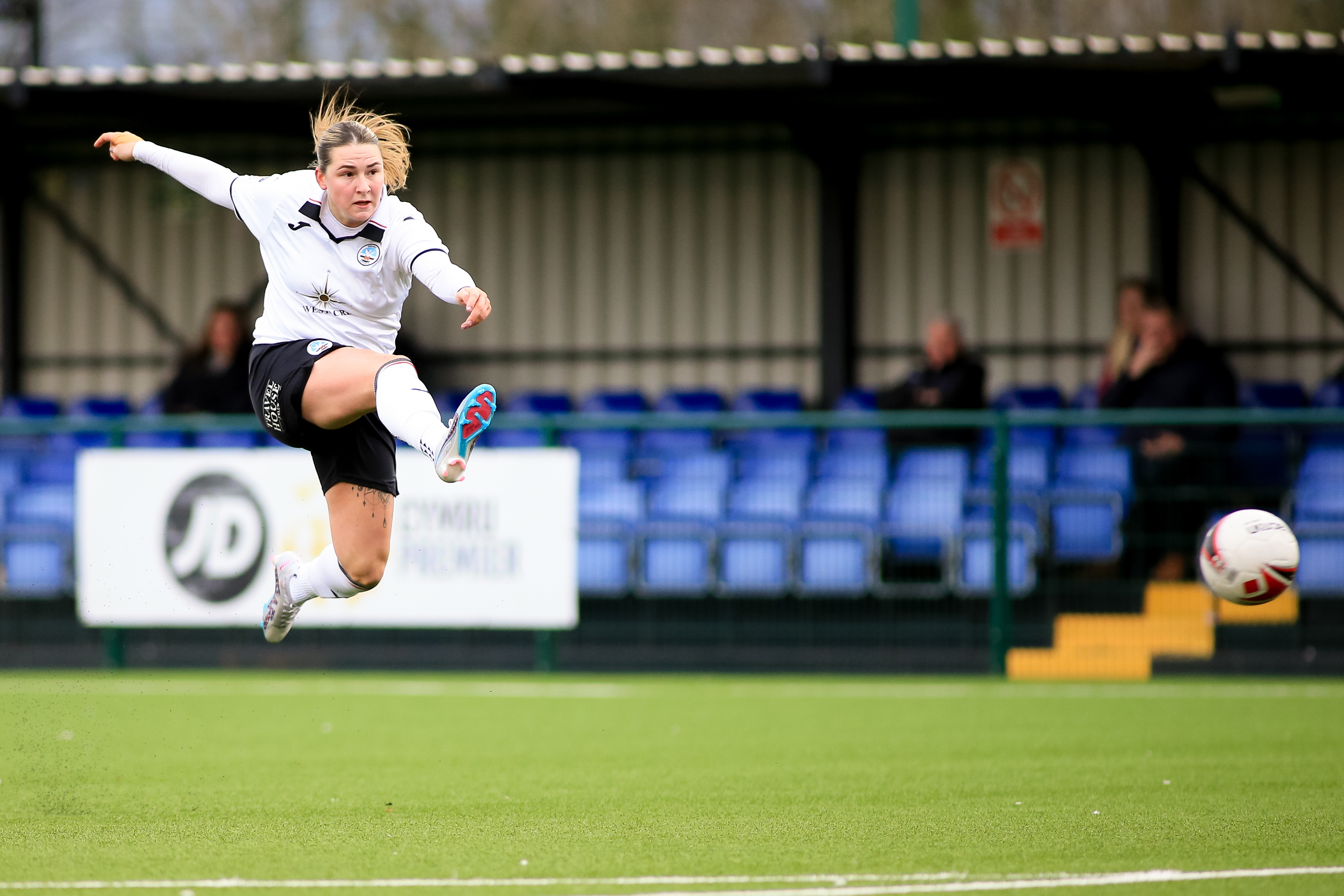 Swansea City striker Chloe Chivers takes a shot at goal.