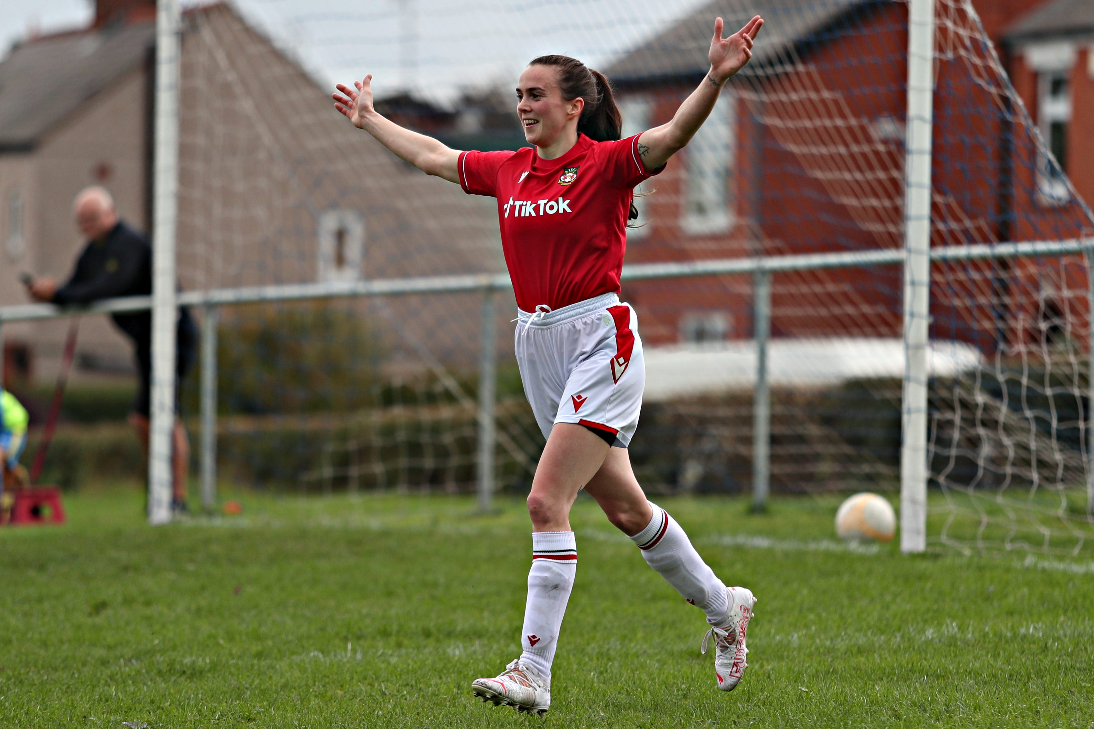 Rosie Hughes celebrates scoring a goal for Wrexham against Llanfair United.