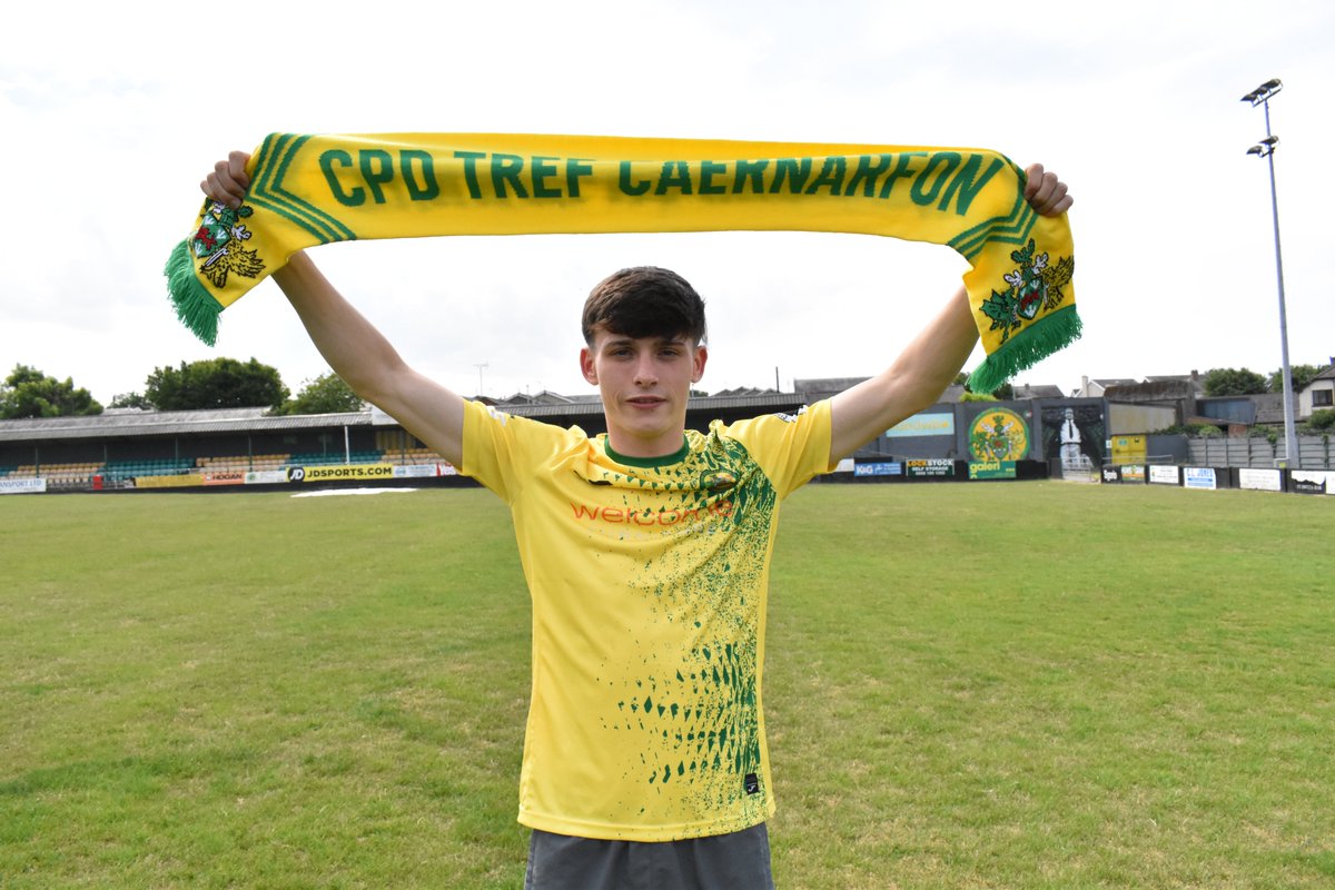 Louis Lloyd holds up a Caernarfon Town scarf.