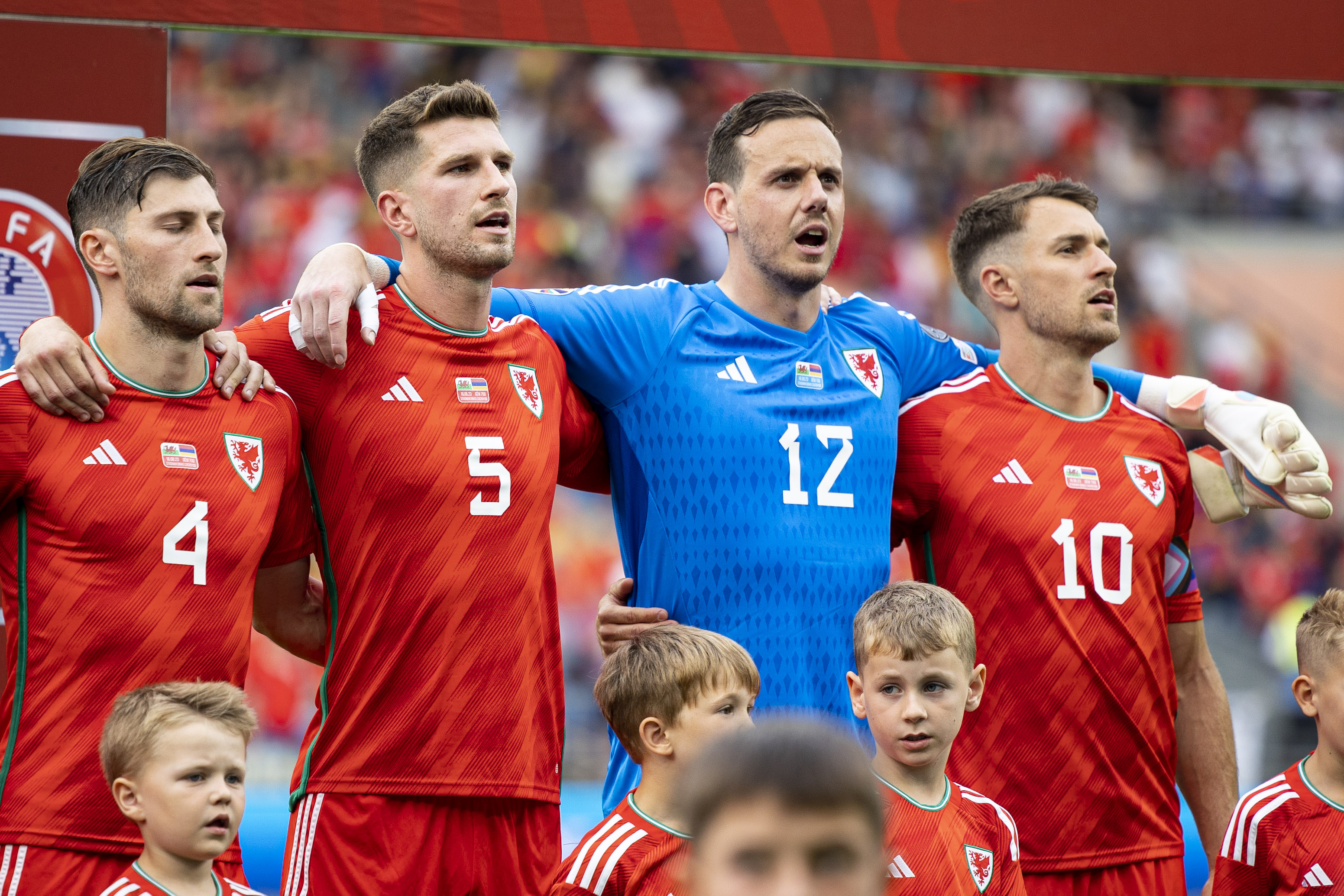 Ben Davies, Chris Mepham, Danny Ward and Aaron Ramsey sing the Wales national anthem