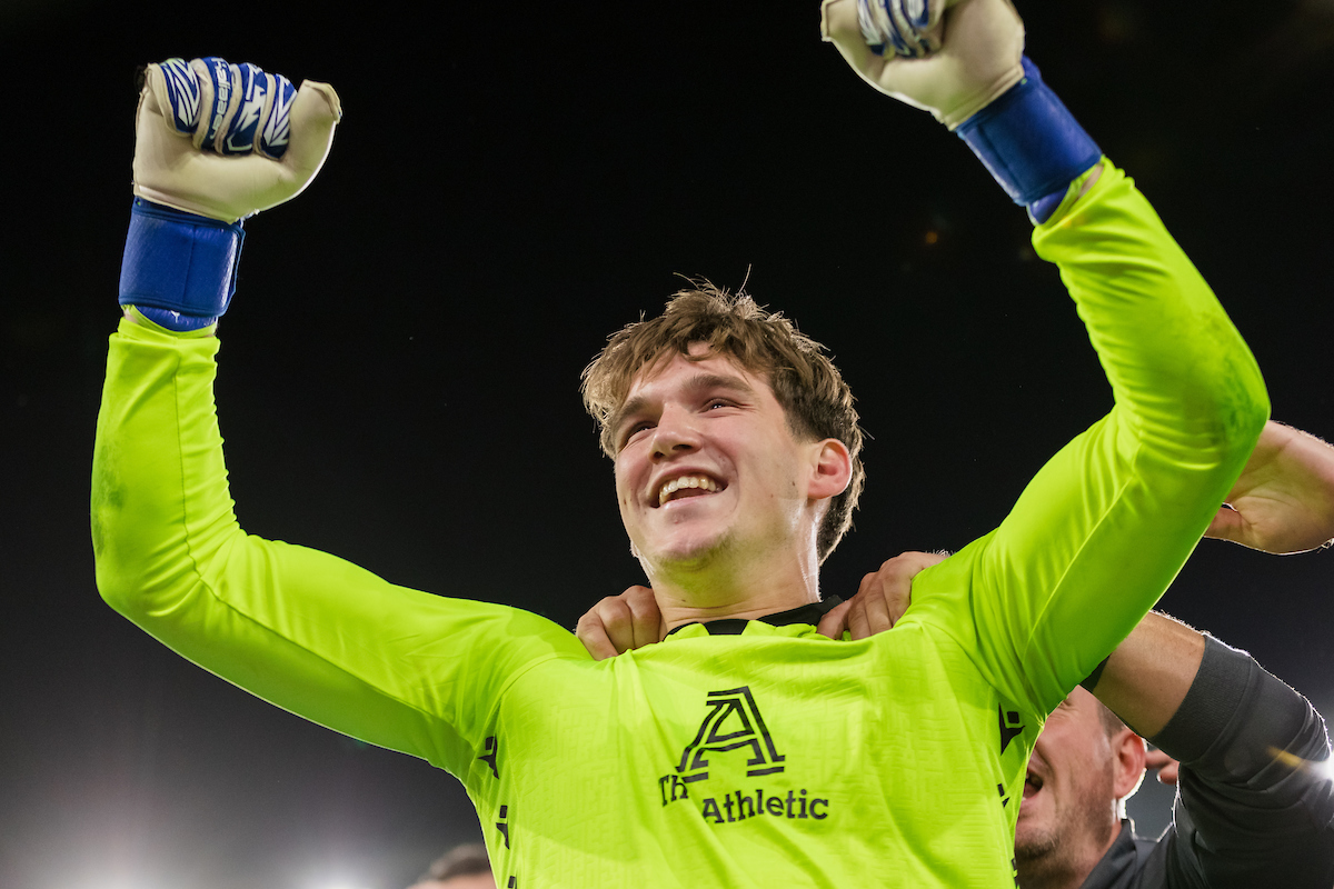 Haverfordwest goalkeeper Zac Jones raises his arms in celebration.