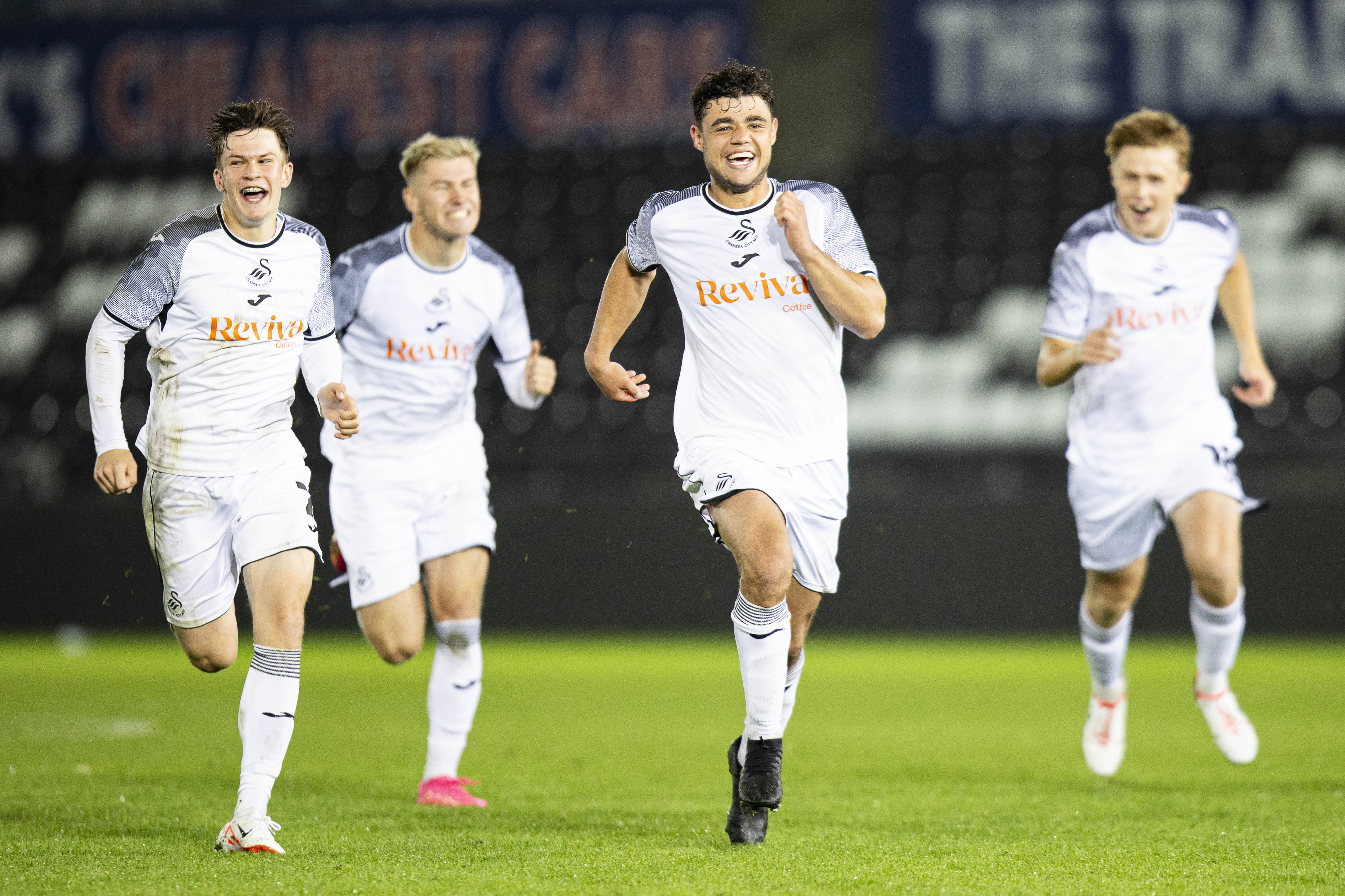 Swansea City players celebrate their penalty shootout win against Cardiff City.