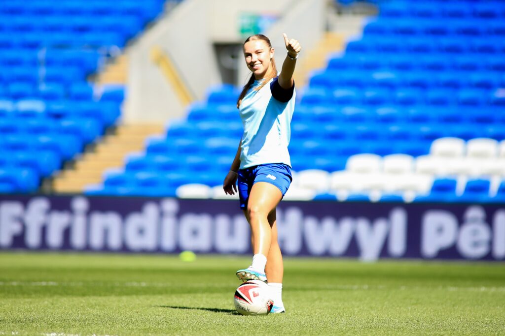 Cardiff City midfielder Seren Watkins poses for the camera as she puts her thumb up looking directly into the camera.