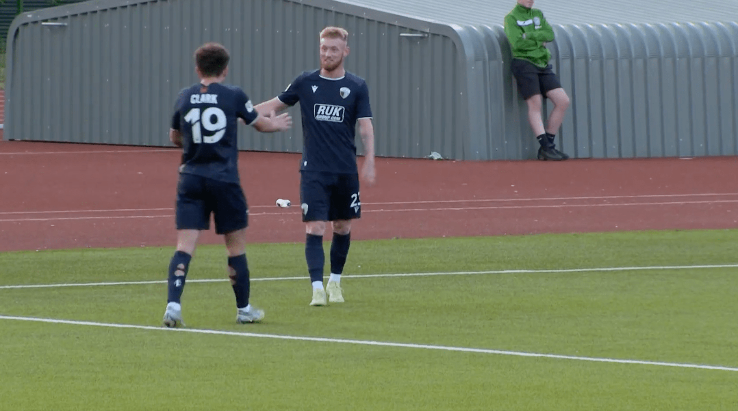 TNS striker Brad Young celebrates wth teammate Ben Clark after scoring