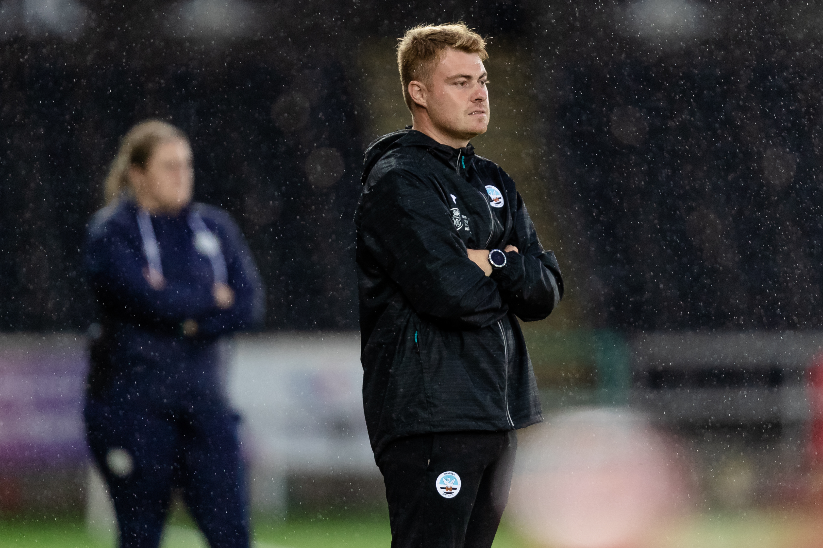 Swansea City head coach Ceri Phillips standing on the touchline.