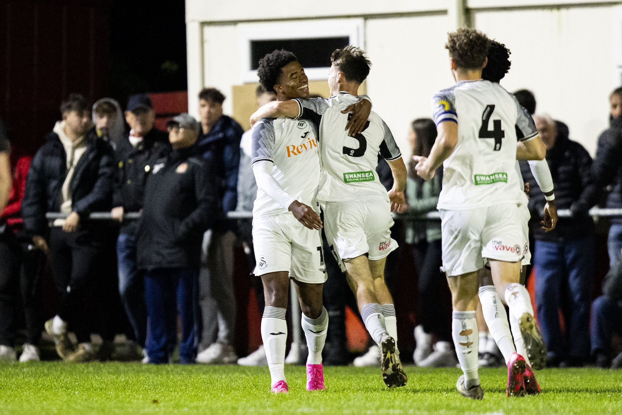 Swansea City players celebrate against Briton Ferry