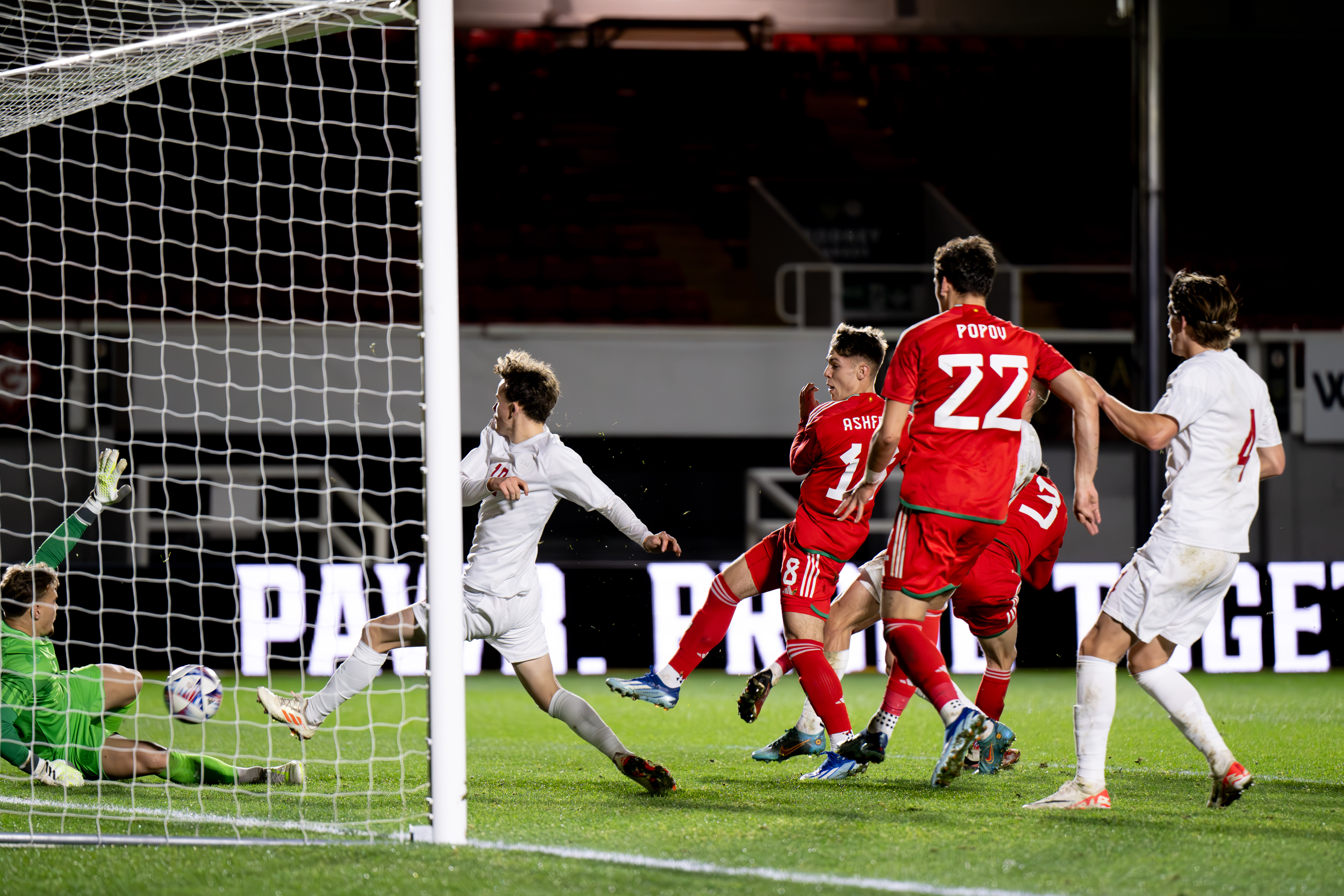 Cian Ashford scores a goal for Wales against Denmark.