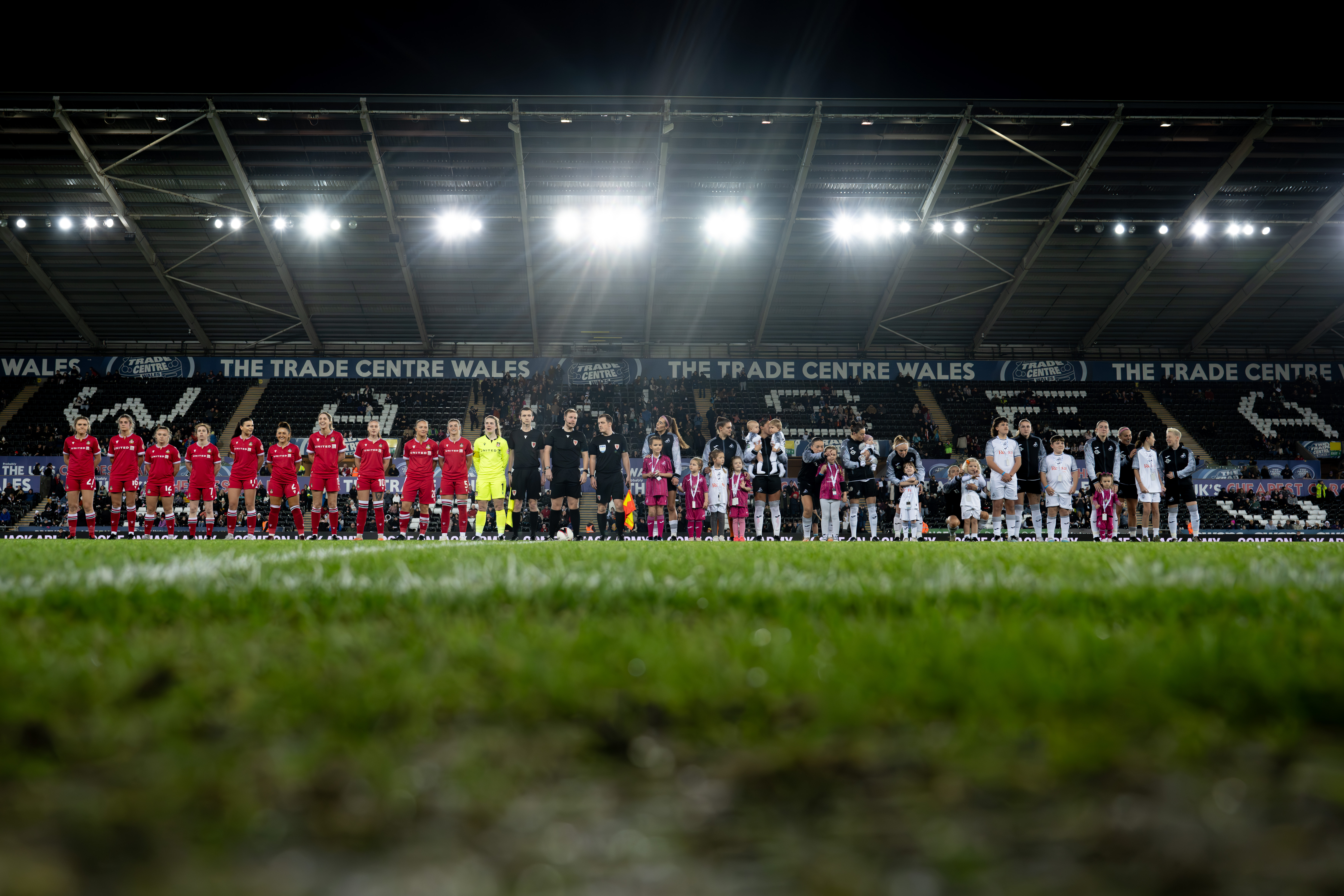 Swansea City and Wrexham Women's players line up at the Swansea.com Stadium.