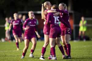 Cardiff City players celebrate with Molly Kehoe.