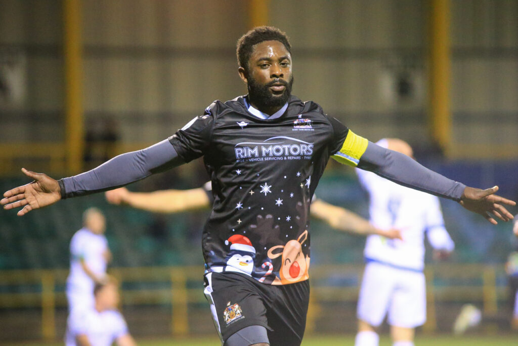 Kayne McLaggon celebrates scoring for Barry Town against Penybont.