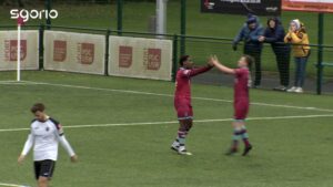 Udi Akpan celebrates with a teammate after scoring Colwyn Bay's first goal.