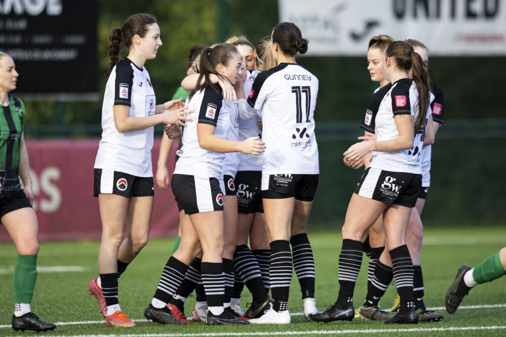 Pontypridd United Women's players celebrate around Jasmine Turner after she scored a penalty