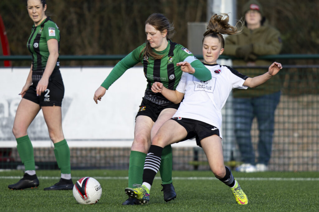 Amy Jenkins of Aberystwyth Town jostles for possession with a Pontypridd United player.