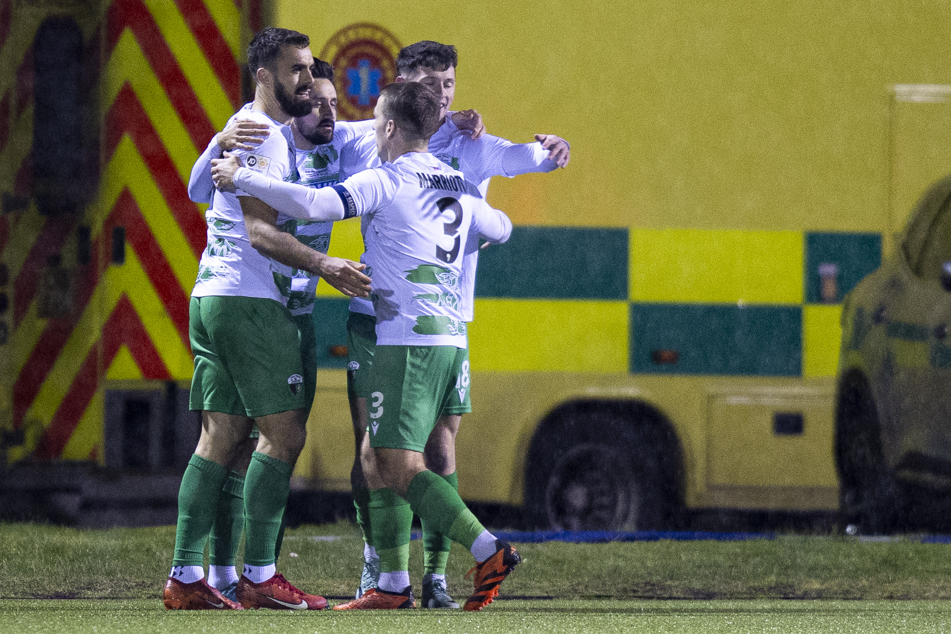 Ryan Brobbel celebrates with his TNS teammates after scoring against Swansea City in the Nathaniel MG Cup final