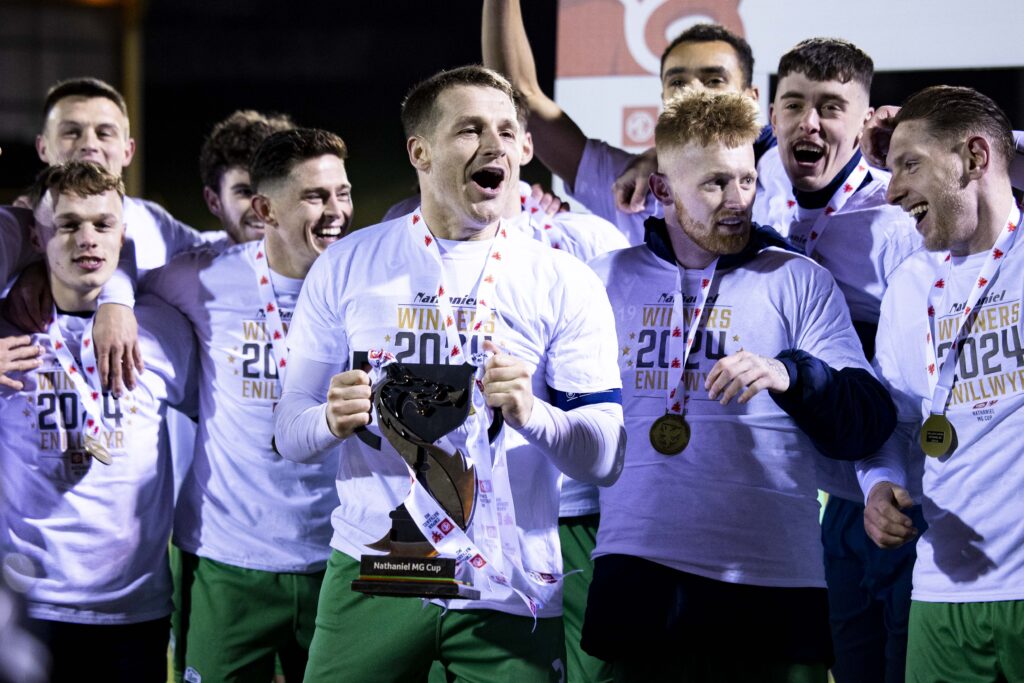 Chris Mariott - the captain of TNS - lifts the Nathaniel MG Cup with his teammates. 