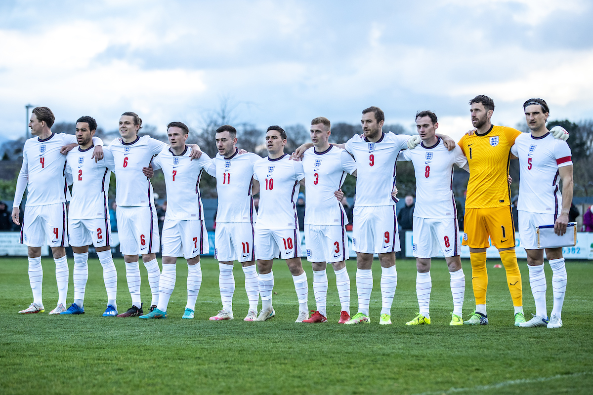 England C squad line up against Wales at Caernarfon Town's Oval in 2022