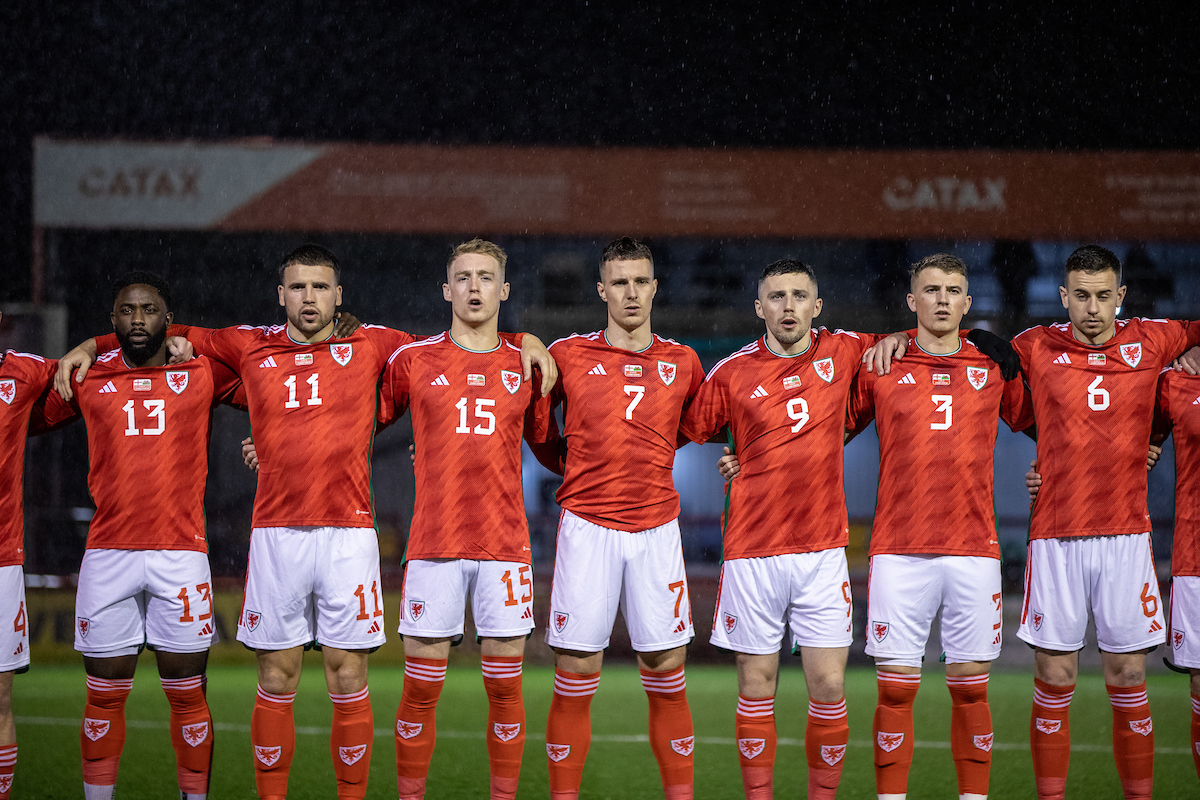 Wales C players Kayne McLaggon, Clayton Green, Sam Jones, Tom Price, Mael Davies and Danny Davies sing the Wales national anthem