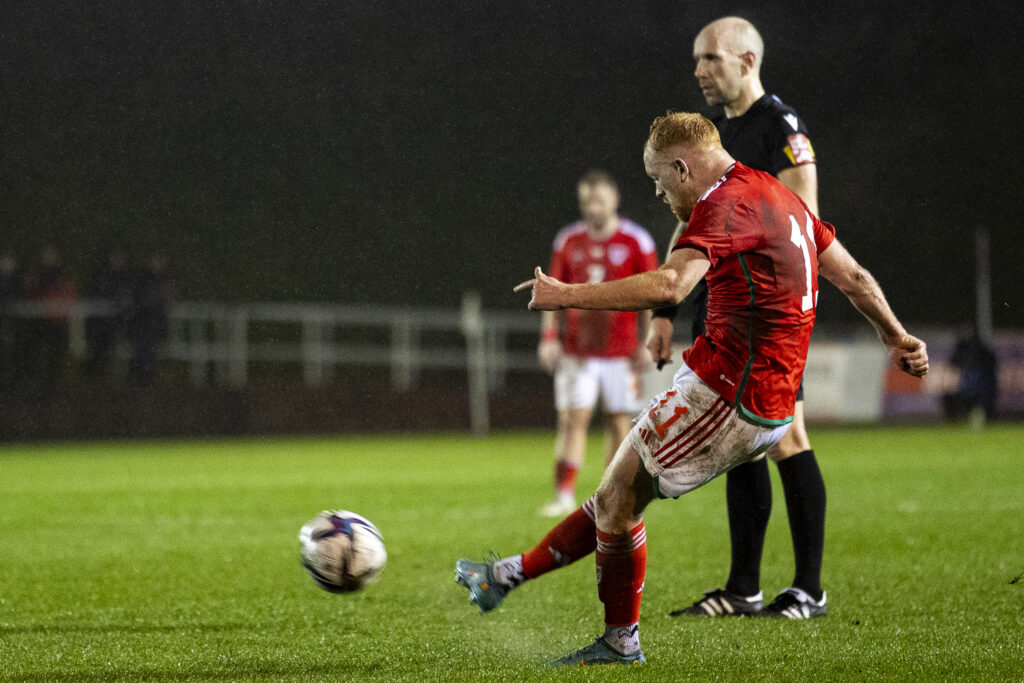 Sion Bradley scores his free kick for Wales C against England C