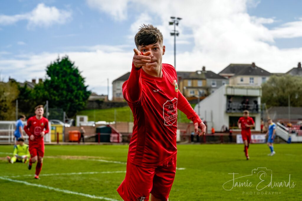 Thomas Hillman celebrates scoring for Llanelli Town against Pontardawe 