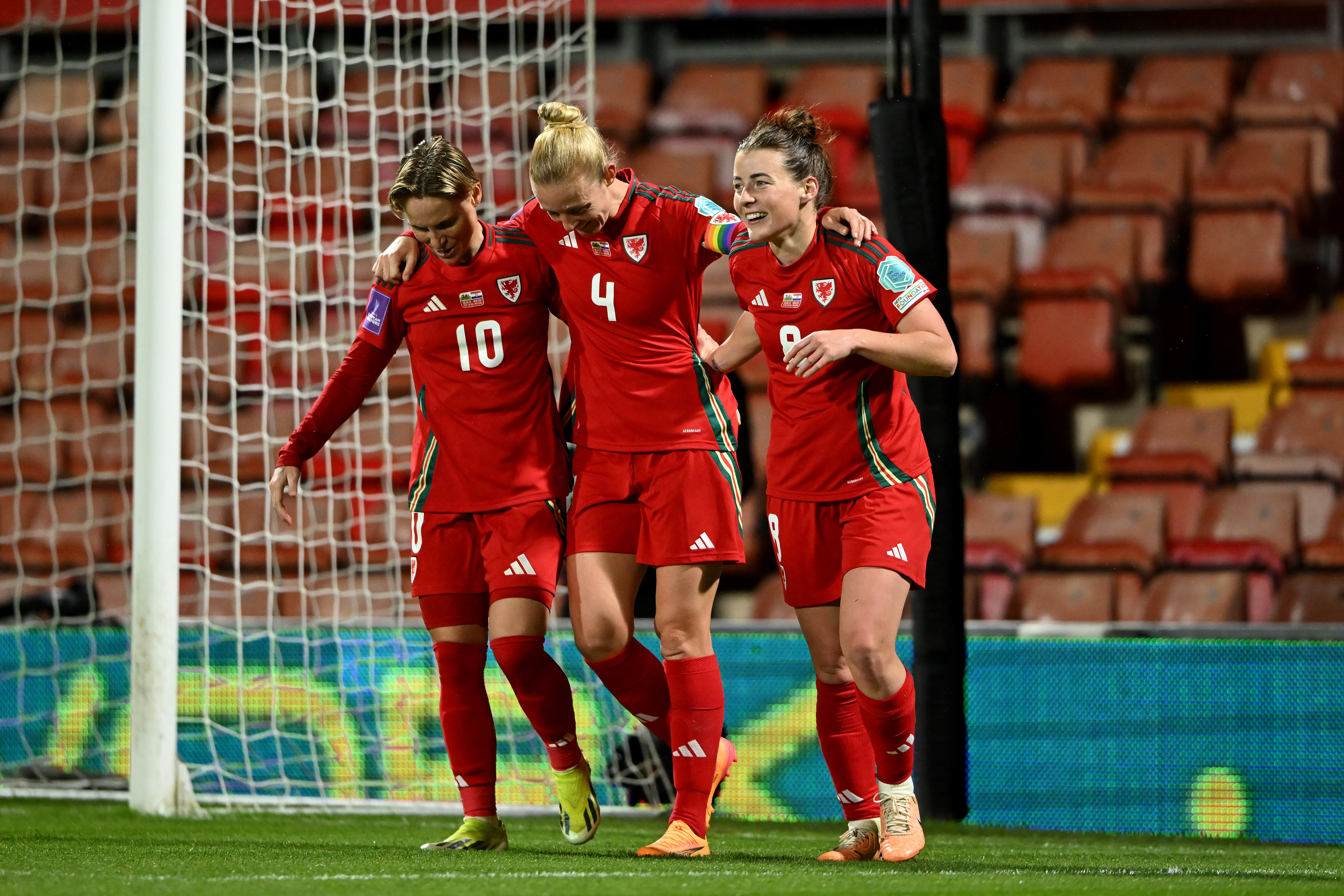 Angharad James celebrates with her teammates after scoring Wales fourth goal.