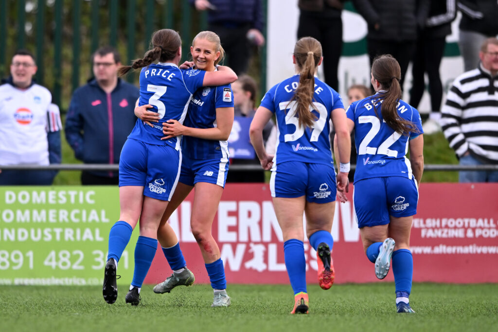 Rhianne Oakley celebrates with her Cardiff City teammates after scoring a goal against Swansea City