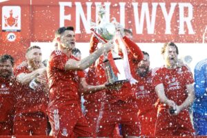 Mike Wilde and John Disney lift the Welsh Cup after beating TNS