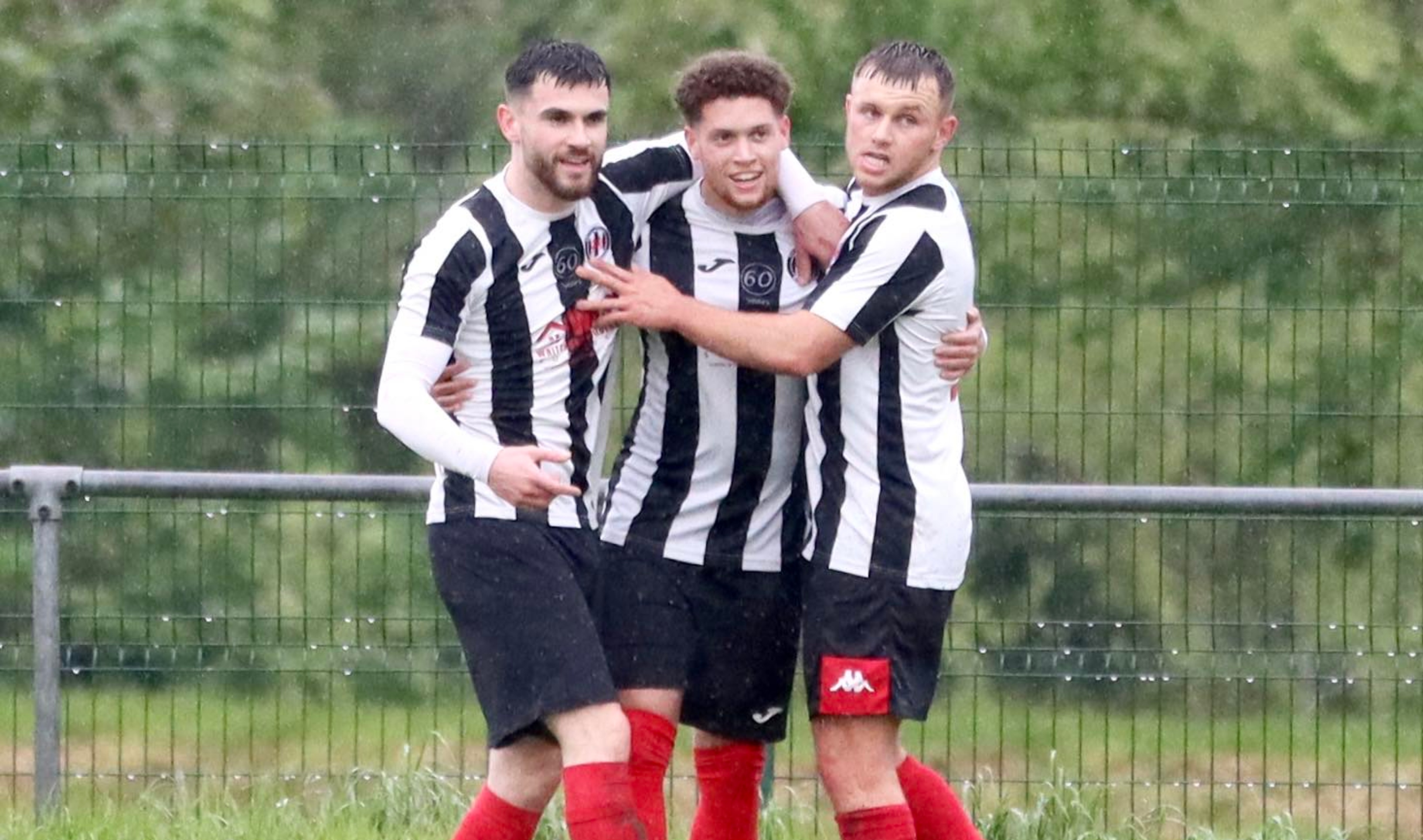 Myles Corson celebrates with his Cardiff Dracs teammates after scoring against Penrhiwceiber Rangers