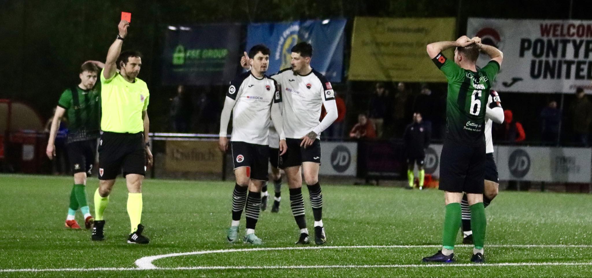 Bryn Markham-Jones shows Aberystwyth Town's Jack Thorn a red card against Pontypridd United.