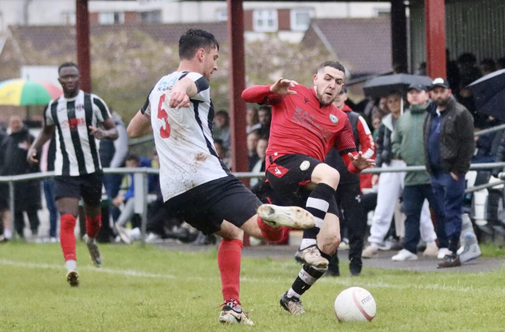 Cardiff Dracs defender Oscar Raisbeck defends the ball against a Penrhiwceiber Rangers attacker