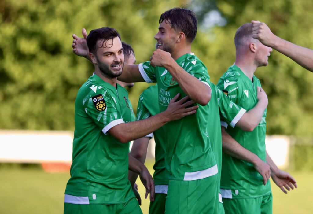 Henry Jones celebrates with his Llanelli Town teammates after scoring against Taffs Well in the Cymru South.