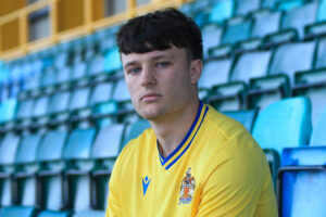 Rhys Schwank sits in the stands after joining Cymru Leagues club Barry Town