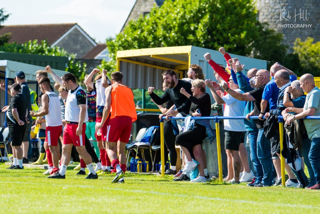 The Trethomas Bluebirds bench celebrates after they score against Llantwit Major.