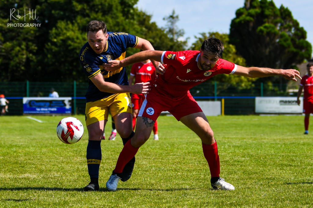 A Llantwit Major and a Trethomas Bluebirds player battle for the ball.