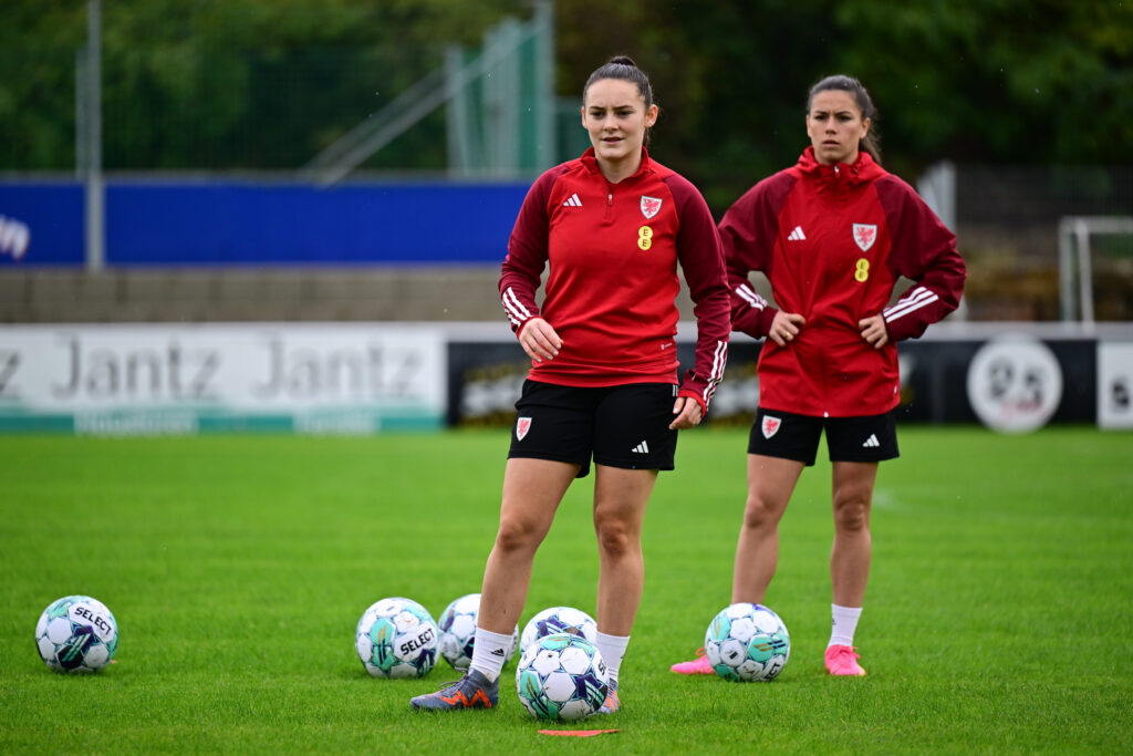 Maria Francis-Jones stands over a ball during a Wales training session