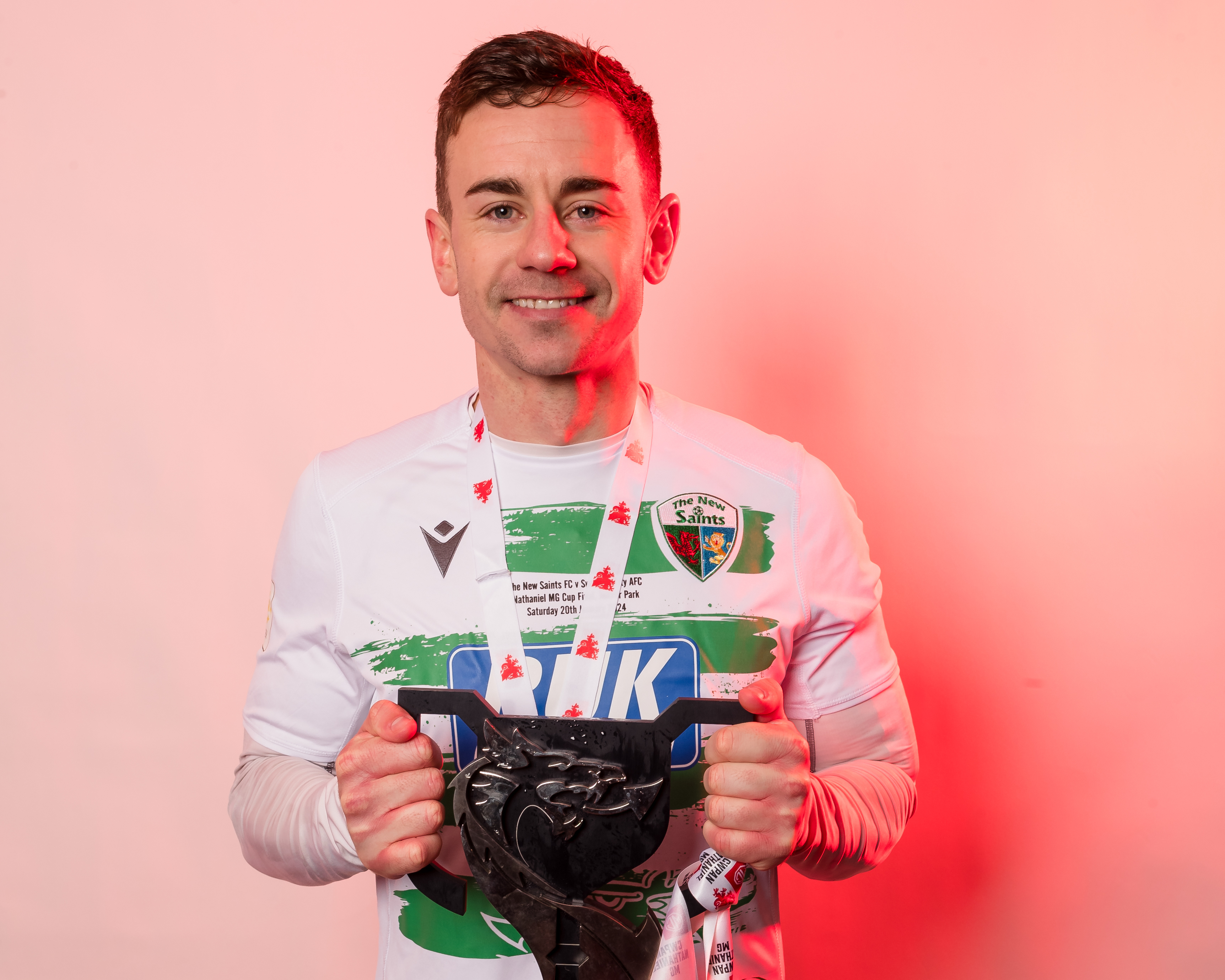 The New Saints' Daniel Davies poses with the trophy after winning the 2023/24 Nathaniel MG Cup Final fixture between The New Saints FC and Swansea City U21 AFC, Jenner Park Stadium, Barry, Wales