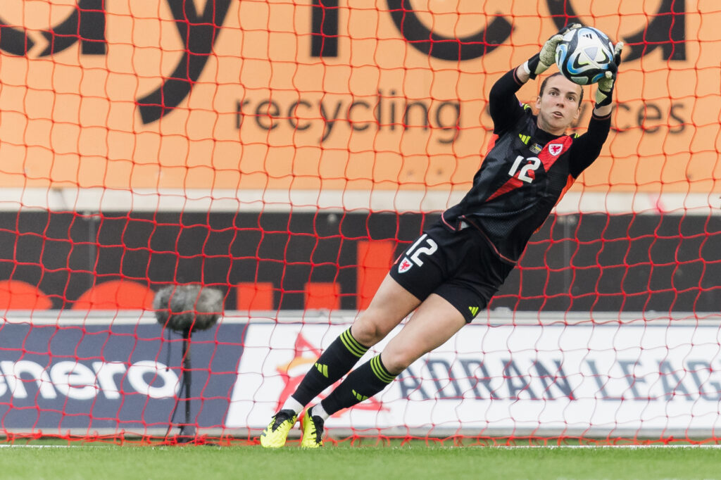 Wales goalkeeper Olivia Clark saves a shot during a UEFA Women's EURO 2025 qualifier between Wales and Ukraine