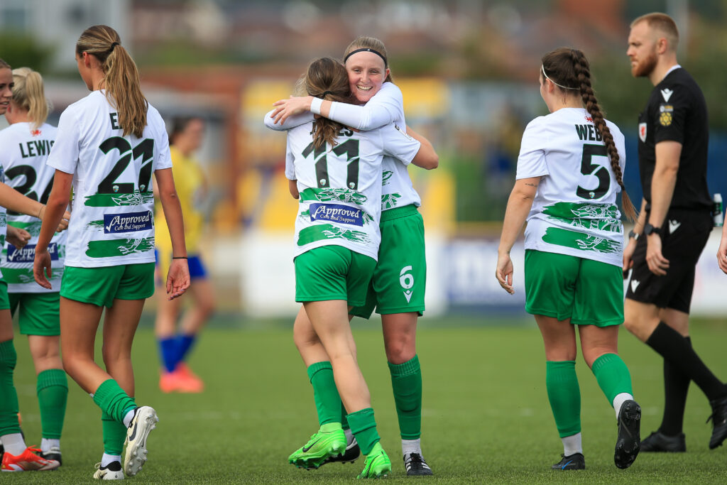 TNS celebrate scoring at Jenner Park against Barry Town