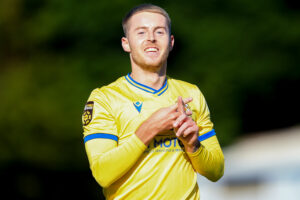 Keenan Patten celebrates scoring Barry Town United's first goal as they beat Briton Ferry Llansawel at Jenner Park