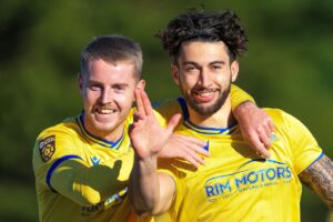 Ollie Hulbert celebrates scoring for Barry Town United as they beat Briton Ferry Llansawel 3-1 in Cymru Premier at Jenner Park along with Keenan Patten