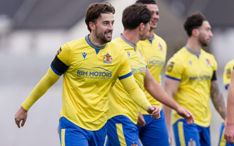 BARRY, WALES - 26 DECEMBER 2025: Merthyr Town's Ben Williams-Margetson scores a overhead kick to make it 1-0 and celebrates during the 2025/26 JD Cymru Premier fixture between Barry Town United FC & Cardiff Metropolitan University FC at Jenner Park Stadium, Barry, Wales