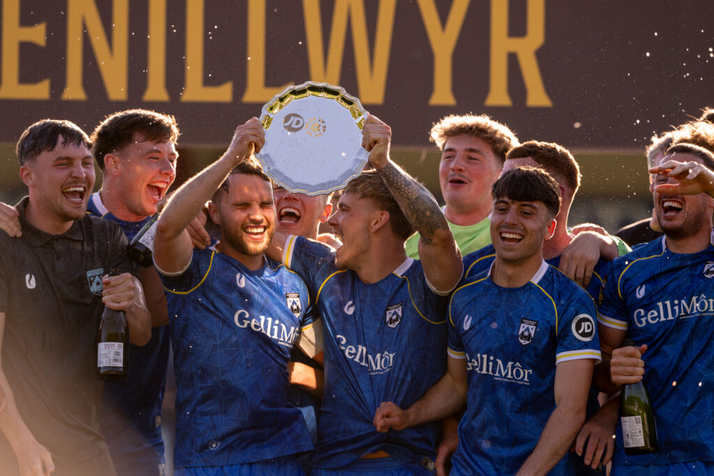Haverfordwest County lift the trophy during the JD Cymru Premier 24/25 - European Play Off match between Haverfordwest County AFC and Caernarfon Town at Ogi Bridge Meadow Stadium in Haverfordwest on the 18th May 2025