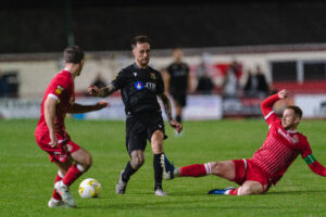 Alex Bonthron of Llanelli Town and Alex Gammond of Briton Ferry Llansawel during the JD Cymru Premier 2025/26 fixture Briton Ferry Llansawel vs Llanelli Town at The Renewable Centre Stadium, Briton Ferry, Wales