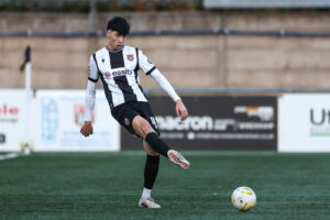 FLINT, WALES - 20 DECEMBER 2025: Isaac Lee of Flint Town in action during the JD Cymru Premier between Flint Town and Haverfordwest County at the Cae y Castell in Flint.