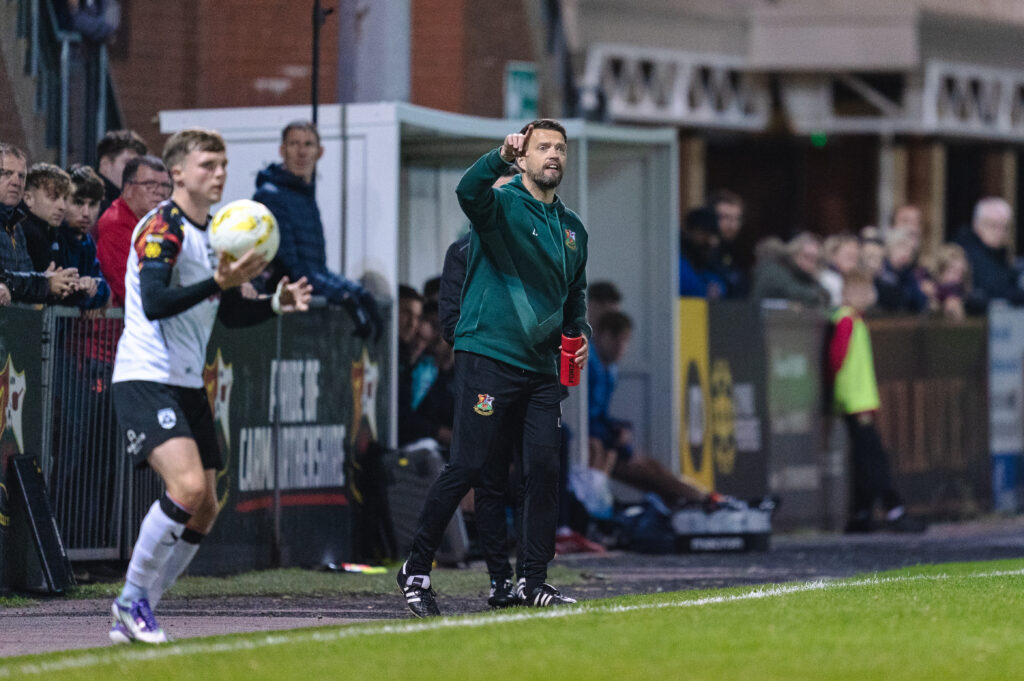 Llanelli Town manager Lee John issues instructions on the touchline