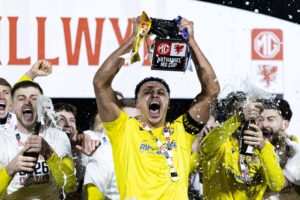 BRIDGEND, WALES - 28 FEBRUARY 2026: Barry Town's Callum Sainty lifts the trophy during the 2025/26 Nathaniel MG Cup Final fixture between The New Saints FC & Barry Town United AFC at the Dragonbet Stadium, Bridgend, Wales